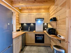 a kitchen with wooden walls and wooden counters at la brume des cimes in Bussang