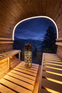 a sauna with a bench and a window with a view at la brume des cimes in Bussang +25 photos