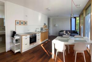 a kitchen and living room with a table and chairs at Falterweg in Immenstaad am Bodensee