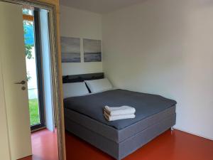 a bedroom with a bed with a mirror next to it at Falterweg in Immenstaad am Bodensee