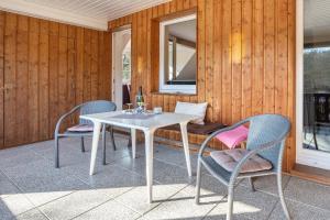a white table and chairs on a patio at Haus Wacholder in Undeloh