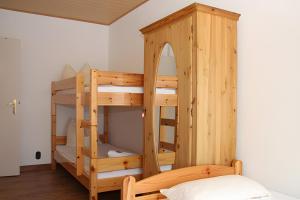 a wooden bunk bed in a room with a mirror at Ferienwohnung Jule in Sonthofen