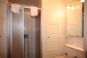 a bathroom with a shower and a toilet and a sink at Ferienwohnung Jule in Sonthofen +13 photos