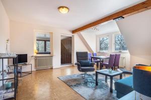 a living room with a table and chairs at Haus Wacholder in Undeloh