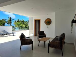 a living room with chairs and a table at Sol de Arena Beachfront, Las Terrenas in Las Terrenas