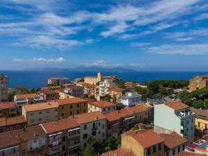 a city with buildings and the ocean in the background at Holy days in Piombino