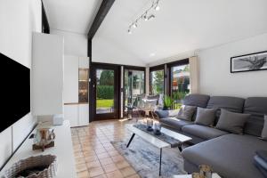 a living room with a couch and a table at Ferienhaus Sauerland am Hennesee in Meschede
