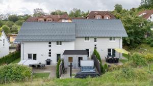 an aerial view of a white house with a roof at Ferienhäuser Stickel in Freudenstadt