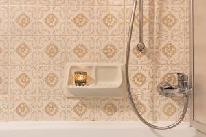 a bathroom with a bath tub with a candle in a holder at Ferienwohnung 1 Vikoler in Vols am Schlern +27 photos
