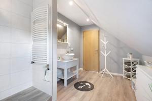 a bathroom with a sink and a toilet in a room at Ferienwohnung Huus 39 in Ostenfeld +14 photos