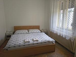 a bedroom with a bed with two shoes on it at Vidiecky Dom in Mojmírovce