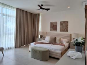 a bedroom with a bed and a ceiling fan at Sol de Arena Beachfront, Las Terrenas in Las Terrenas +36 photos