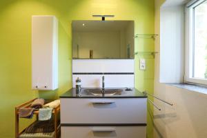 a kitchen with a sink and a mirror at Gite les coquelicots Proche mer in Paimpol +35 photos