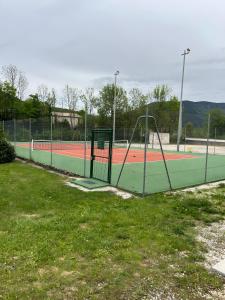 a tennis court with nets on a tennis court at Appartement Duplex Rez Jardin in Montbrun-les-Bains