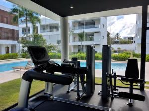 a gym with cardio equipment in front of a building at Sol de Arena Beachfront, Las Terrenas in Las Terrenas