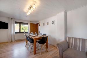 a dining room with a table and chairs at Haus Seezeit in Freilingen