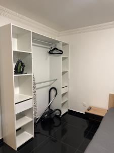 a bedroom with a white closet with a desk at T2 modern in Frontenex-Villard-Rosset