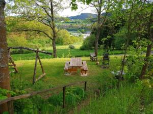 a picnic table in the middle of a garden at Sauerland Alm Winterberg 5 mit Pool in Hallenberg