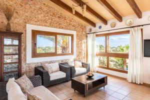 a living room with a couch and a tv at Finca Can Jeroni in Felanitx