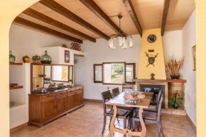 a kitchen with a table and a dining room at Finca Can Jeroni in Felanitx