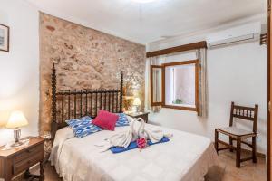 a bedroom with a bed with towels on it at Finca Can Jeroni in Felanitx +19 photos