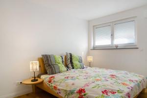 a bedroom with a bed and a window at Casa Ruf in Orsingen-Nenzingen