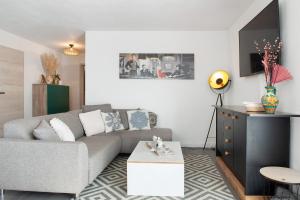 a living room with a gray couch and a table at Casa Ruf in Orsingen-Nenzingen