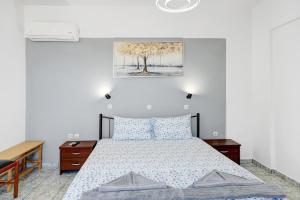 a bedroom with a bed and a painting on the wall at Athina seaside in Kardamaina