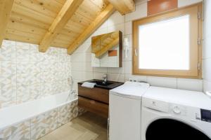 a laundry room with a sink and a washing machine at Lamartine in Valloire +20 photos