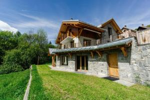 a stone house with a balcony on top of it at Lamartine in Valloire