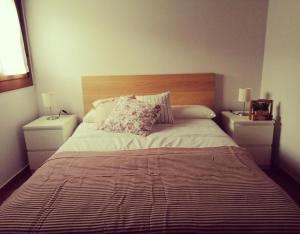 a bedroom with a large bed with two night stands at El Aterpe 5 in Aldehuela del Rincón