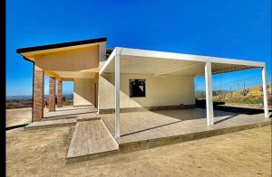 a building with a roof on top of a field at Domus del Gotha in Mazzarino
