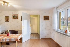 a living room with a table and a window at Haus am Candelaber in Altenbergen