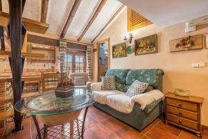 a living room with a couch and a glass table at Tomillo in Hinojares