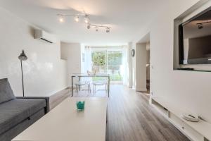 a living room with a couch and a table at Superbe F2 Spacieux - Saint Raphael in Saint-Raphaël