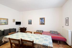 a living room with a table and a couch at Residence Malibu Appartamento 4 in Falcade