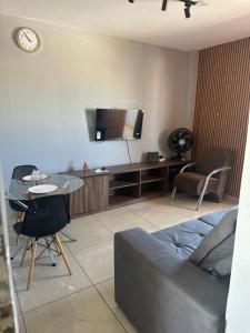 a living room with a couch and a table and a tv at AP inteiro no Brás lado igrejas e comércio andar alto Estacionamento a combinar in São Paulo