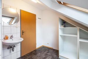 a bathroom with a sink and a door in a room at Knödelhof in Putzbrunn +231 photos