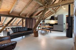 a living room with a couch and a table at Ferienwohnung im Gehöft in Müllheim