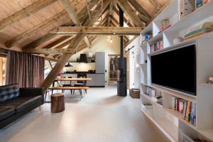 a living room with a large flat screen tv at Ferienwohnung im Gehöft in Müllheim