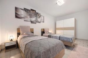 a bedroom with two beds and a mirror at Veith in Hildesheim