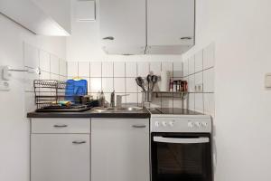 a kitchen with a stove and a sink at Veith in Hildesheim
