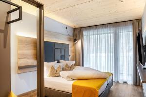 a bedroom with a bed with a yellow blanket on it at Apartment Steinbock in Pflach