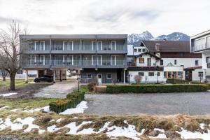 an apartment building with a parking lot in front of it at Apartment Steinbock in Pflach