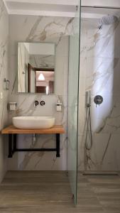 a bathroom with a sink and a glass shower at Villa Mirjan in Sarandë +104 photos