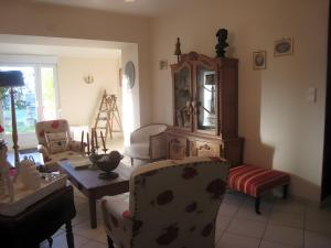 a living room with a chair and a table at Les Charmilles in Charny-sur-Meuse
