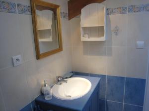 a bathroom with a sink and a mirror at Les Charmilles in Charny-sur-Meuse