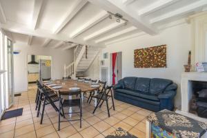 a living room with a table and a couch at Villa Cap mer 17 in Saint-Palais-sur-Mer