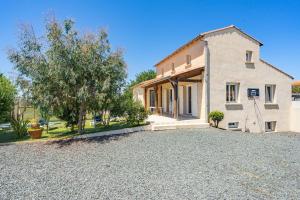 a house with a gravel driveway in front of it at Villa Cap mer 17 in Saint-Palais-sur-Mer