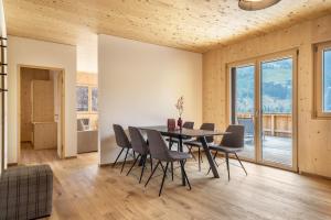 a dining room with a table and chairs at Naturapartments Alpreid Fichte in San Pancrazio dʼUltimo
